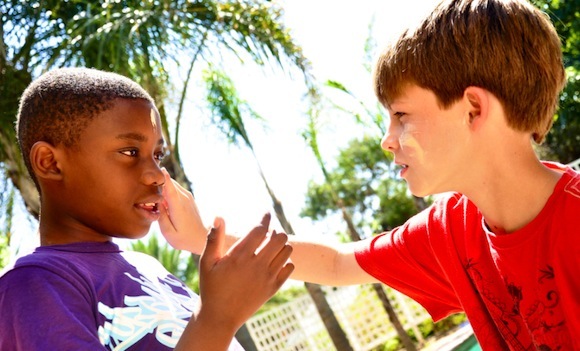 Children applying sunscreen