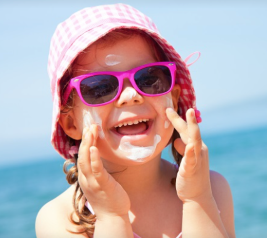 Girl applying sunscreen